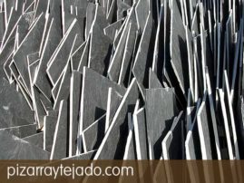 Comercialización de pizarra natural color negro y formato irregular. Pizarra de La Baña (León, España). Pizarra en rama. Pizarra granel.